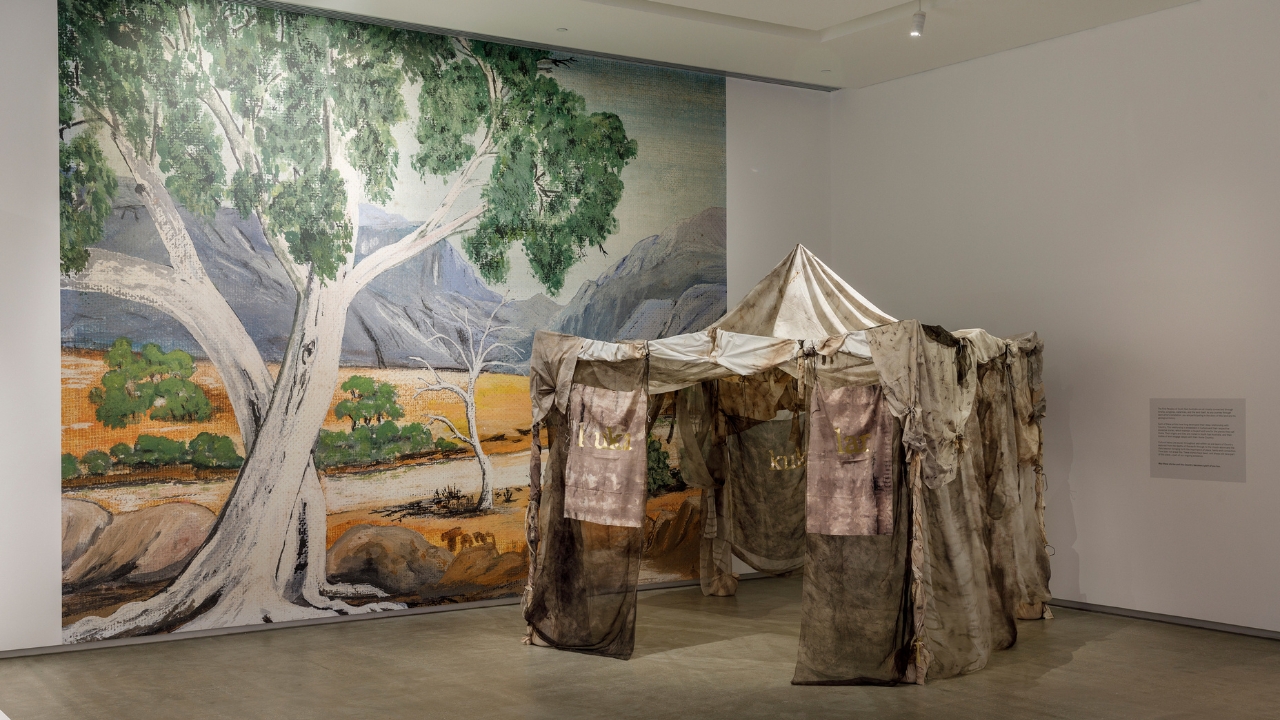 Paola Balla, Murrup (Ghost) Weaving in Rosie Kuka Lar (Grandmother’s Camp) 2021 with Rosie Tang, Untitled Wallpaper, image c. 1978, reproduced 2021, installation view, WILAM BIIK, TarraWarra Museum of Art, 2021. Courtesy of Paola Balla.Photo: Andrew Curtis