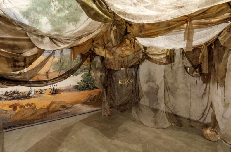 Paola Balla, Murrup (Ghost) Weaving in Rosie Kuka Lar (Grandmother’s Camp) 2021 with Rosie Tang, Untitled Wallpaper, image c. 1978, reproduced 2021, installation view, WILAM BIIK, TarraWarra Museum of Art, 2021. Courtesy Paola Balla.Photo: Andrew Curtis